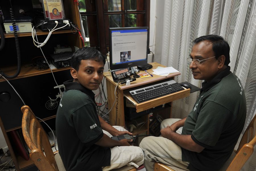 Sri Lanka 4S6YRW 4S6WAS Reshan, 4S6YRW, on the left, holds a 144 MHz handheld transceiver. 