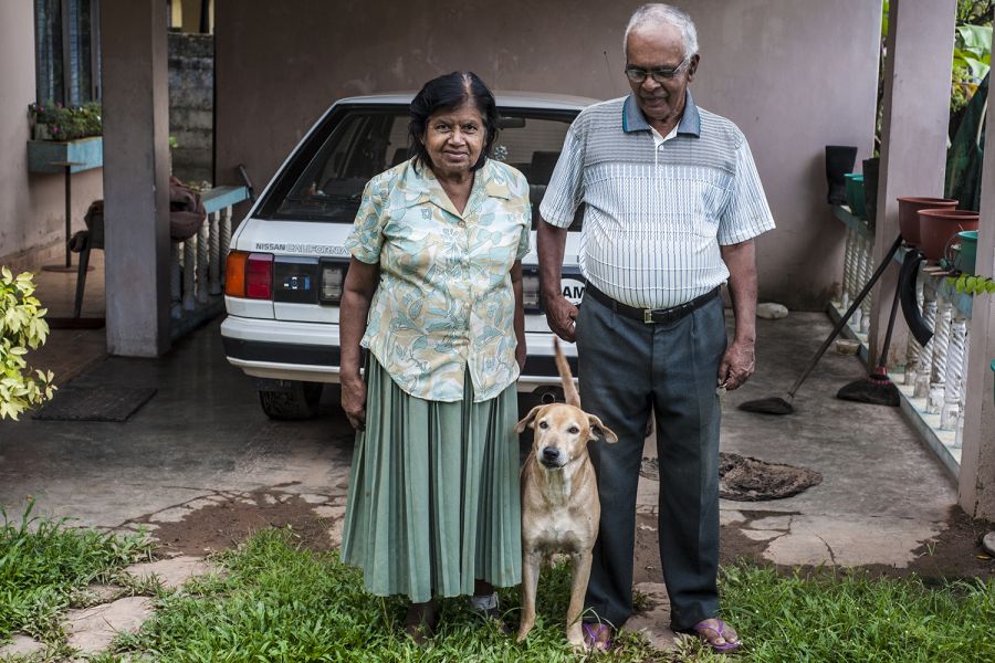 4S7NE Sri Lanka The family picture — Nelson’s wife, one of the dogs in the middle, and Nelson himself on the right. 