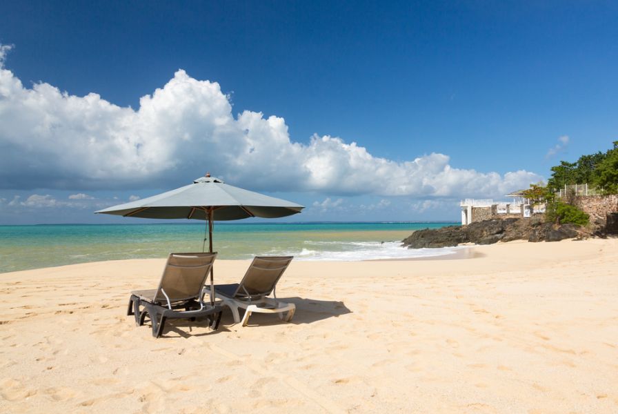 Saint Martin Island FS/DL9USA Reclining beach loungers and umbrella on Baie Rouge. Saint Martin Island FS/DL9USA Reclining beach loungers and umbrella on Baie Rouge.