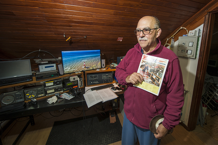 Inside the radio shack of CT1DVV. Antonio shows the CQ Contest magazine with a cover photograph 